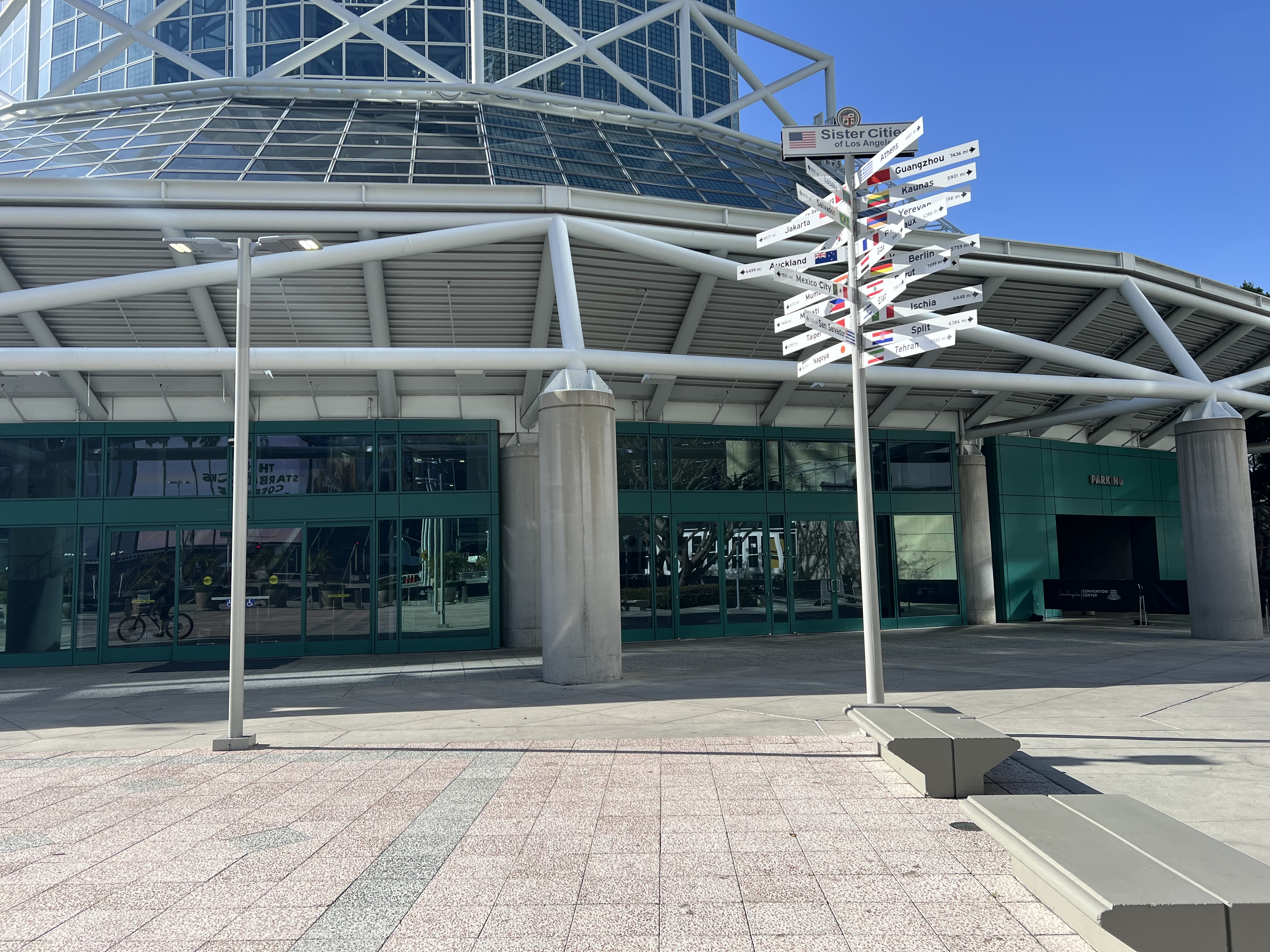 A photo of the Los Angeles Convention Center’s west main entrance, showing the main banks of sliding glass doors