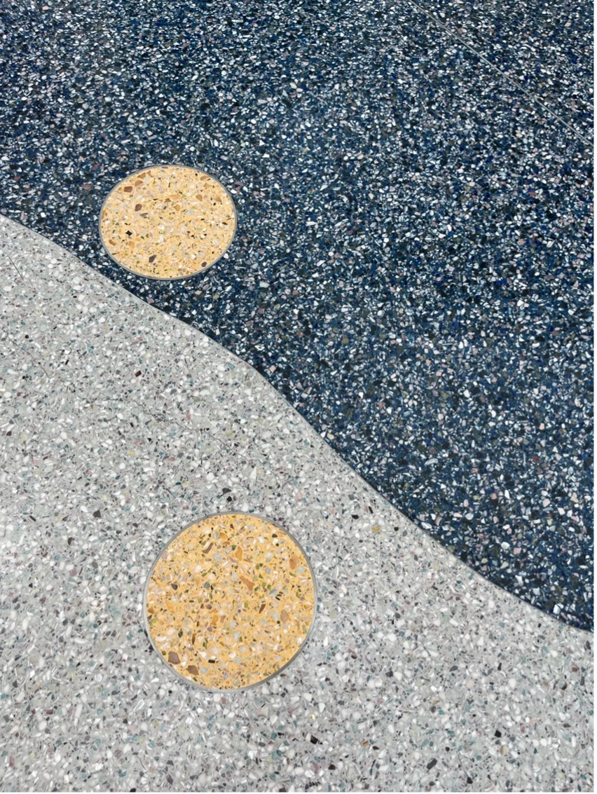 Smooth, speckled tile that covers the floor at the west hall entry.